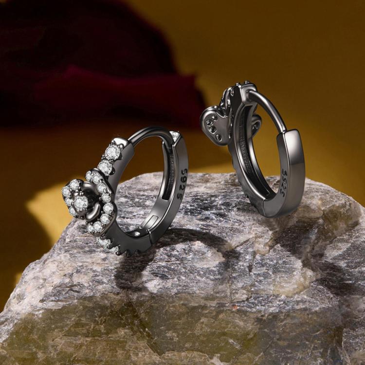 Pair of black hoop earrings with small round zircon stones around a floral cross motif