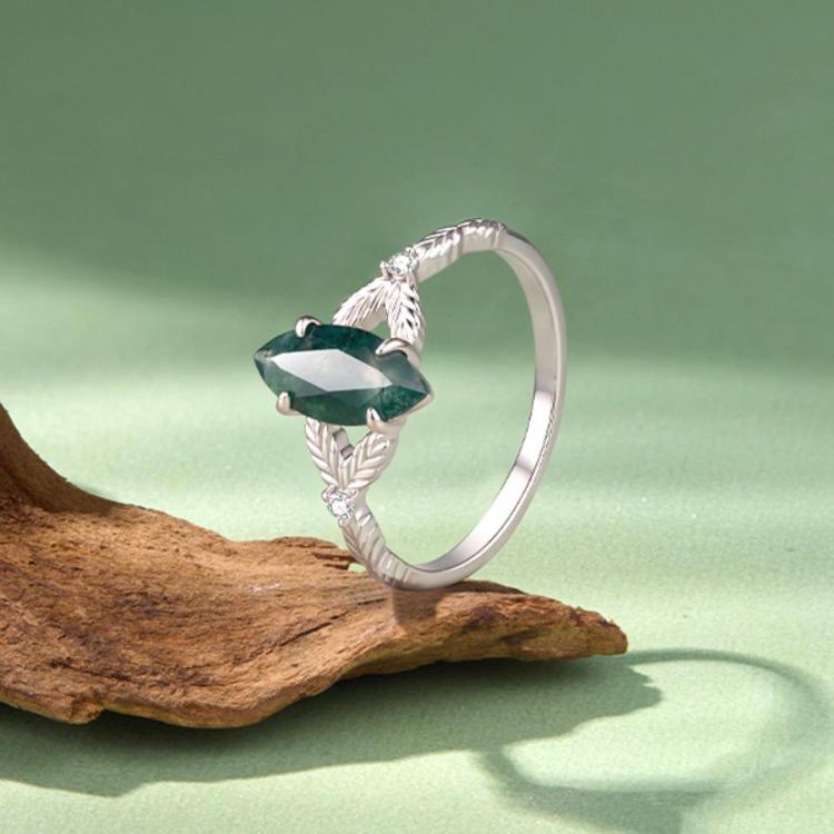 Sterling silver ring with green marquise agate and leaf-textured band, angled view