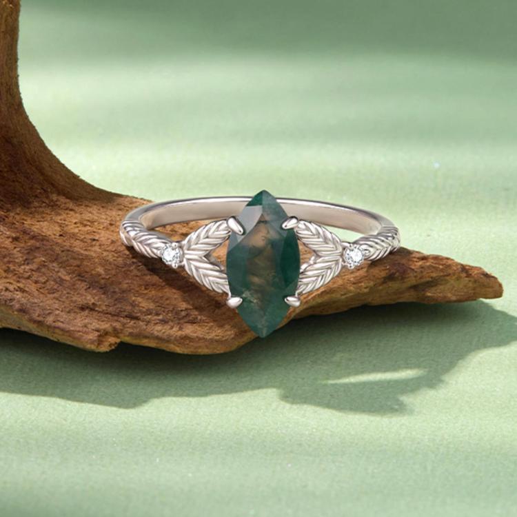 Leaf-braided sterling silver ring with a green marquise agate center and small side stones