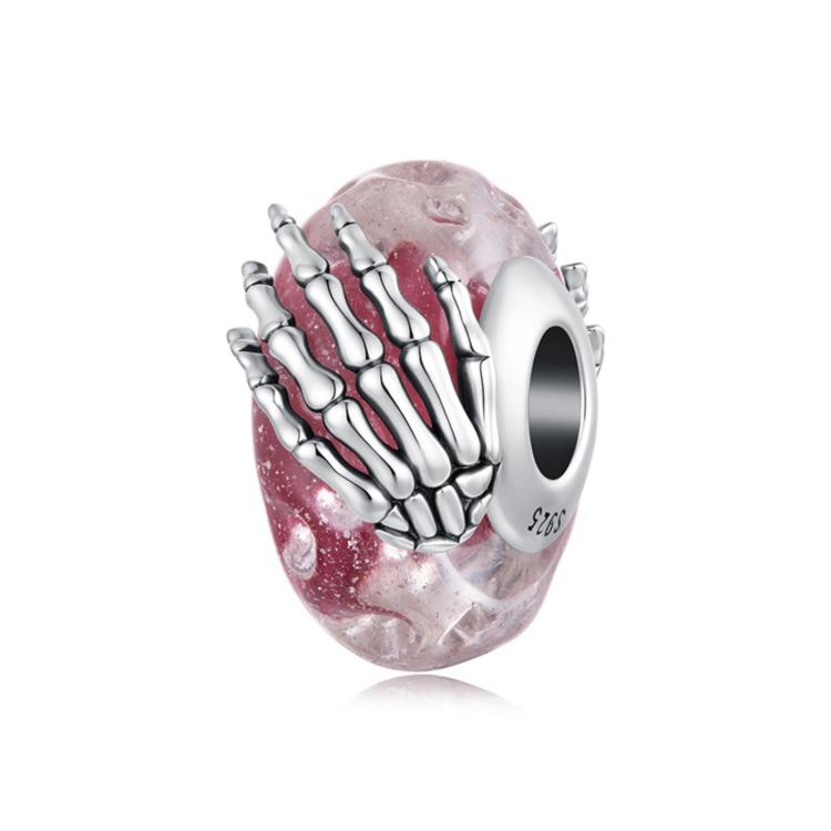 Pink glitter glass bead charm with silver skeleton-hand design and round core hole