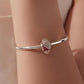 Sterling silver bracelet with pink glitter skeleton-hand glass bead charm on wrist