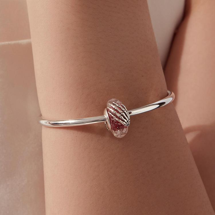 Sterling silver bracelet with pink glitter skeleton-hand glass bead charm on wrist
