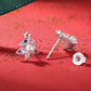 Sterling silver stud earrings with Christmas tree design, pearl center, and blue/pink stones