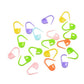 Assorted plastic pin mark clips, scattered multicolored U-shaped connectors