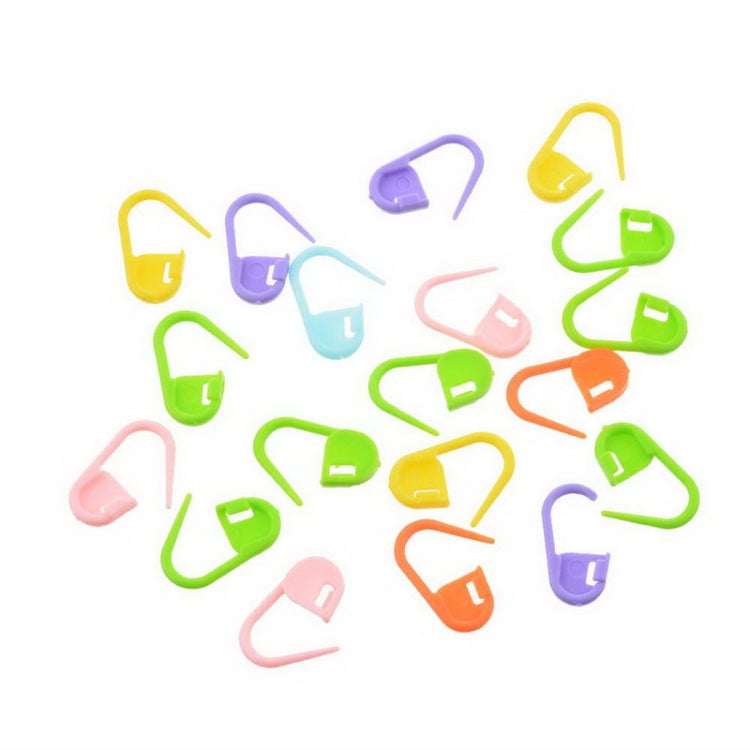 Assorted plastic pin mark clips, scattered multicolored U-shaped connectors