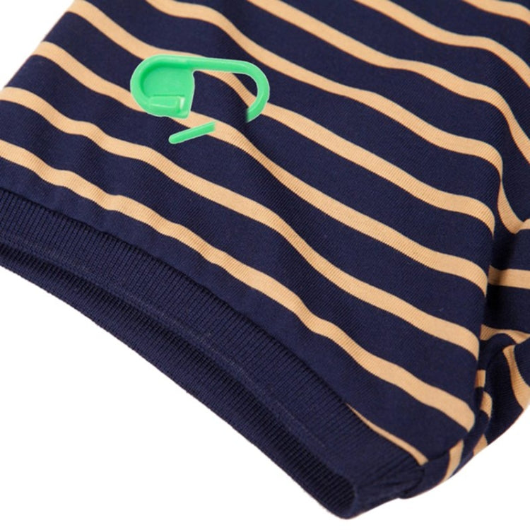 Plastic pin mark clips attached to striped sweater cuff, navy and tan stripes