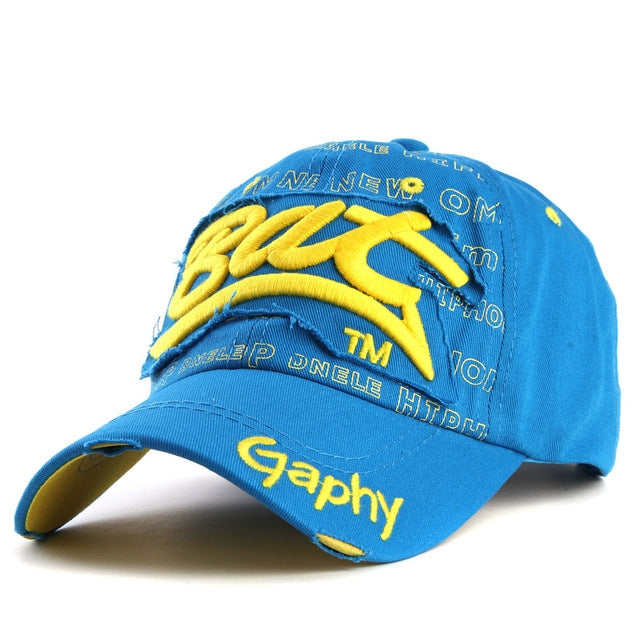Blue baseball cap with yellow embroidered letter pattern and curved brim