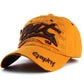 Orange baseball cap with brown embroidered letter pattern and curved brim