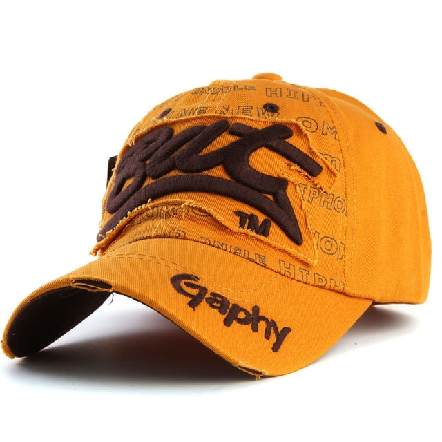 Orange baseball cap with brown embroidered letter pattern and curved brim