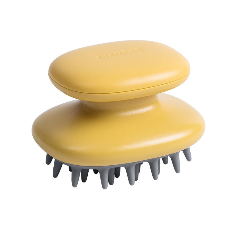 Yellow silicone scalp massage brush with gray bristle pads, compact oval base