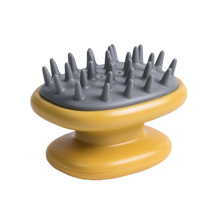 Yellow silicone scalp massage brush underside with gray rubber bristles