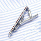 Silver tie clip mechanism holding a red patterned enamel bar