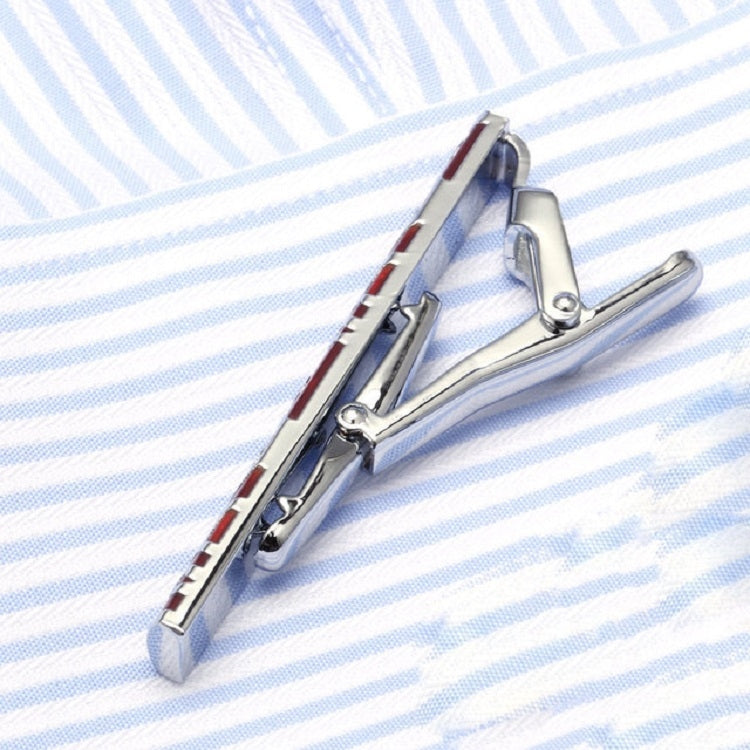 Silver tie clip mechanism holding a red patterned enamel bar