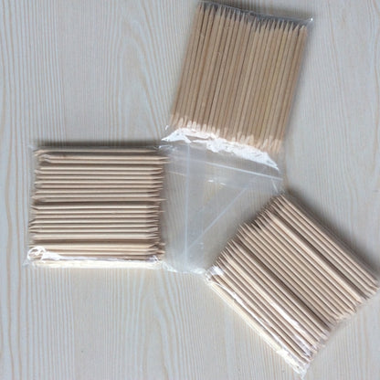 Wooden manicure sticks in clear plastic packaging, multiple packs