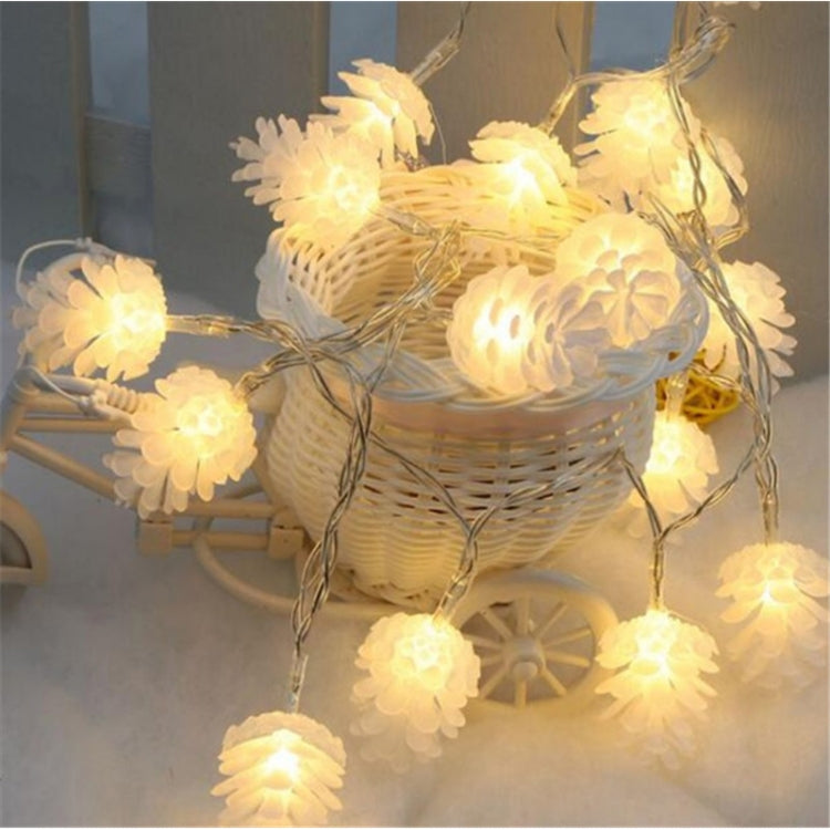 Warm white pine cone LED string lights with soft golden glow on a hanging wire
