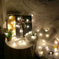 Warm white pine cone LED string lights with glowing bulbs on a thin outdoor-style wire
