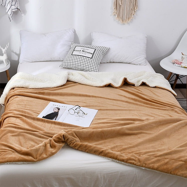 Velvet sofa blanket in warm tan plush fabric, laid across a sofa bed