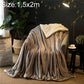 Double-thick sofa blanket in silver gray velvet fleece, folded and draped