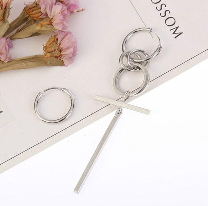Silver-tone long asymmetric earrings with stacked hoops and a straight bar drop.