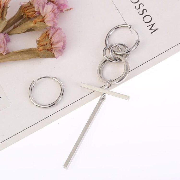 Silver-tone asymmetric long earrings featuring linked hoops and a straight bar detail.