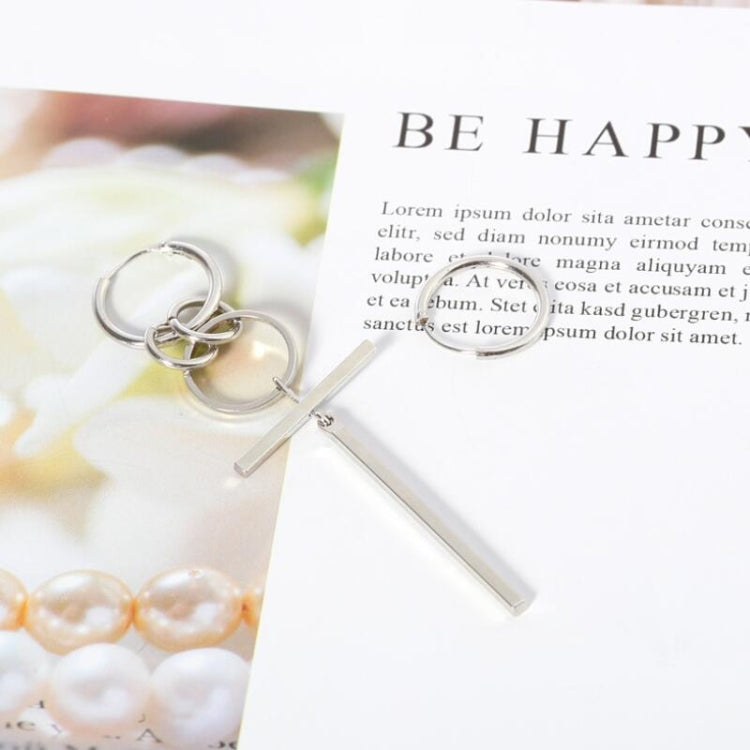 Silver-tone asymmetric long earrings with hoop rings and a long straight bar pendant.