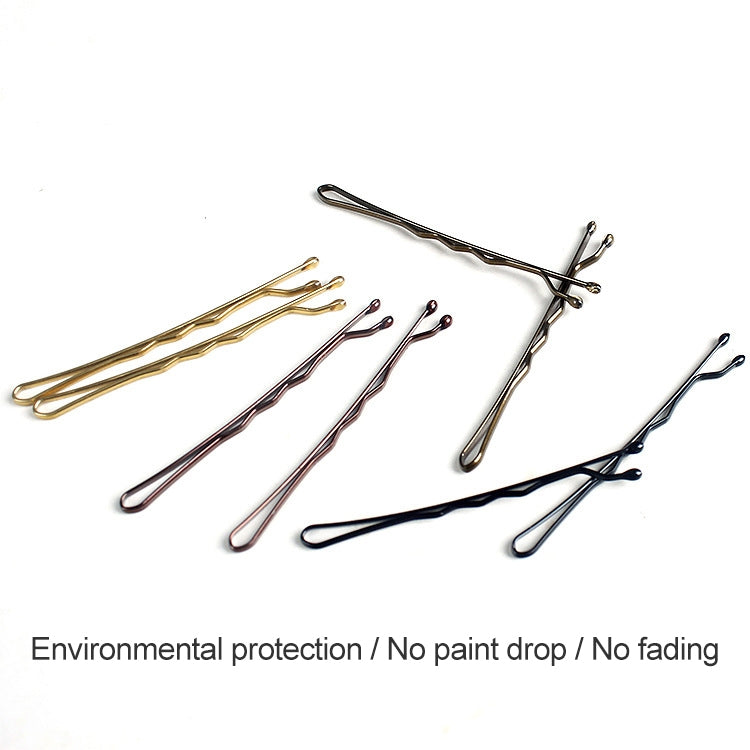Assorted bobby pin set with gold, black, and rose-tone accents, laid out