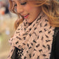 Beige cat-print chiffon scarf worn around the neck with soft drape