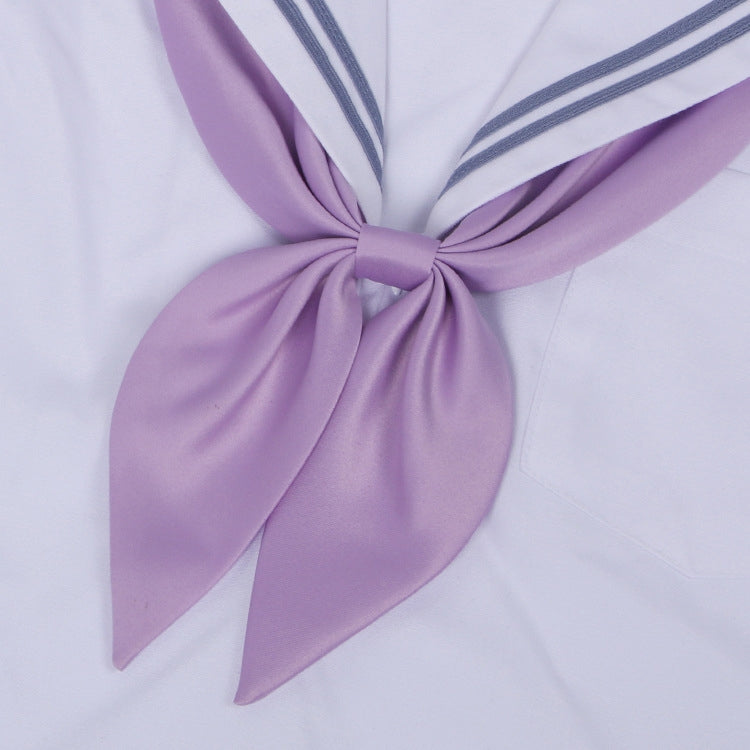 Goldfish-knot bow tie in lavender purple with a centered knot on a white shirt collar.