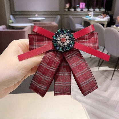 Red plaid bow brooch with jeweled diamond centerpiece and matching red ribbon bow