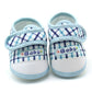Pair of baby prewalker shoes with light blue plaid and “Baby” label on toe