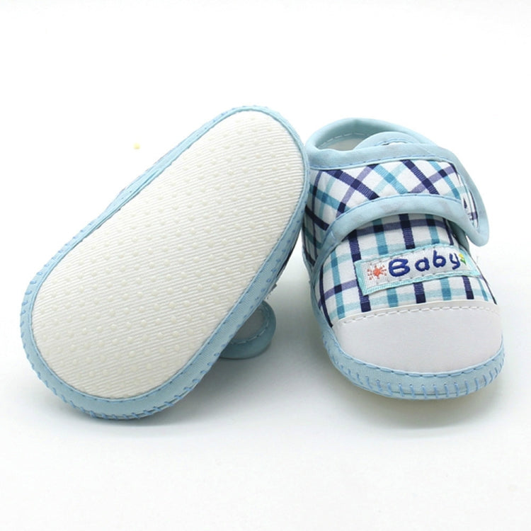 Baby prewalker shoes with blue plaid uppers and soft rubber sole, open heel view
