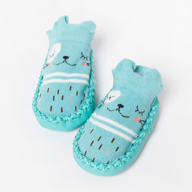 Pair of light blue cartoon animal non-slip toddler socks with striped pattern and grippy sole