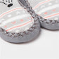 Gray non-slip toddler socks with textured grip sole and stitched trim