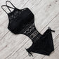 Black hollow lace one-piece swimsuit with halter straps and tie-side hip details