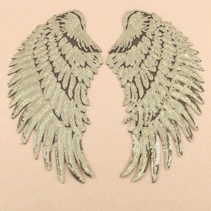 Pair of silver sequin feather wing patches, wing-shaped with scalloped edges