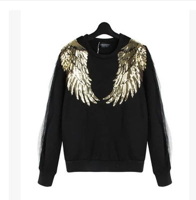 Gold sequin feather wing patches on a black long-sleeve sweatshirt