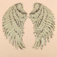 Pair of silver sequin feather wing patches with intricate feather-like pattern