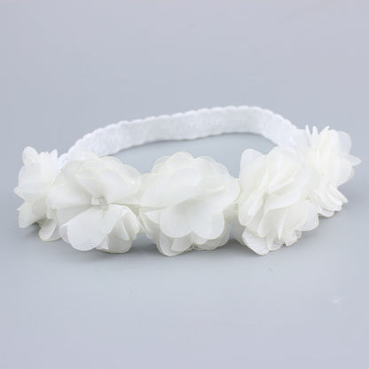 White baby flower headband with layered fabric rosette flowers and soft elastic band