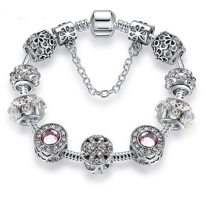Silver-tone charm bracelet with pink crystal center bead, clear faceted beads, lobster clasp
