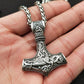 Engraved metal Viking hammer pendant necklace with braided cord, shown on hand