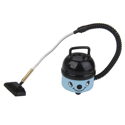 Blue mini dollhouse vacuum cleaner with black canister, flexible hose, and flat floor brush