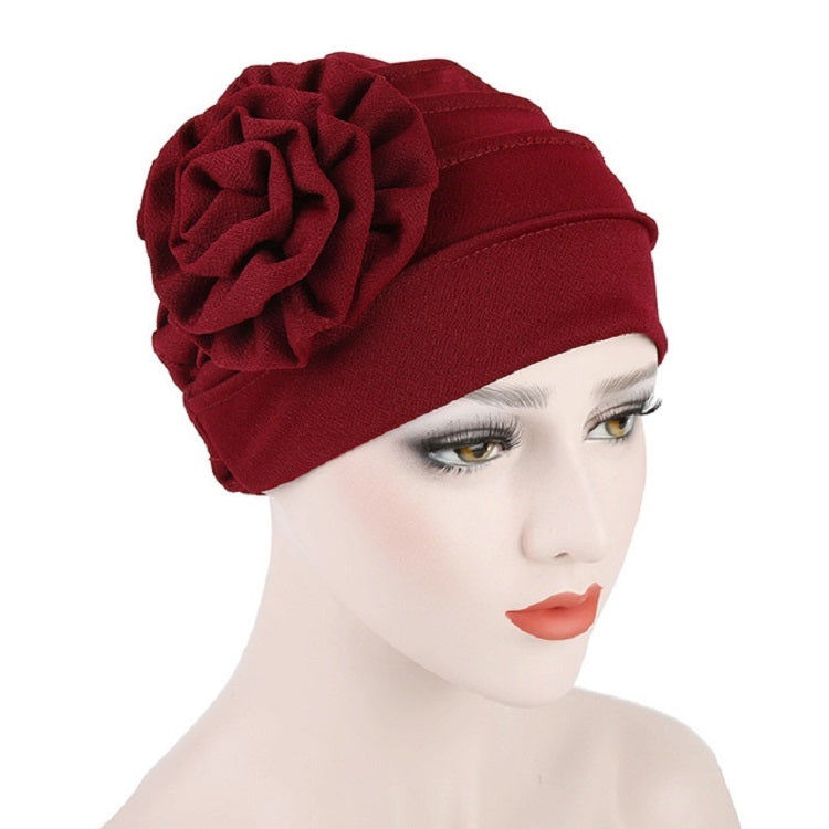 Women’s red turban hat with side rosette flower detail, adjustable fit