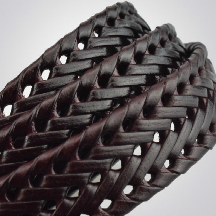 Close-up of black braided leather belt weave with glossy lacquer finish