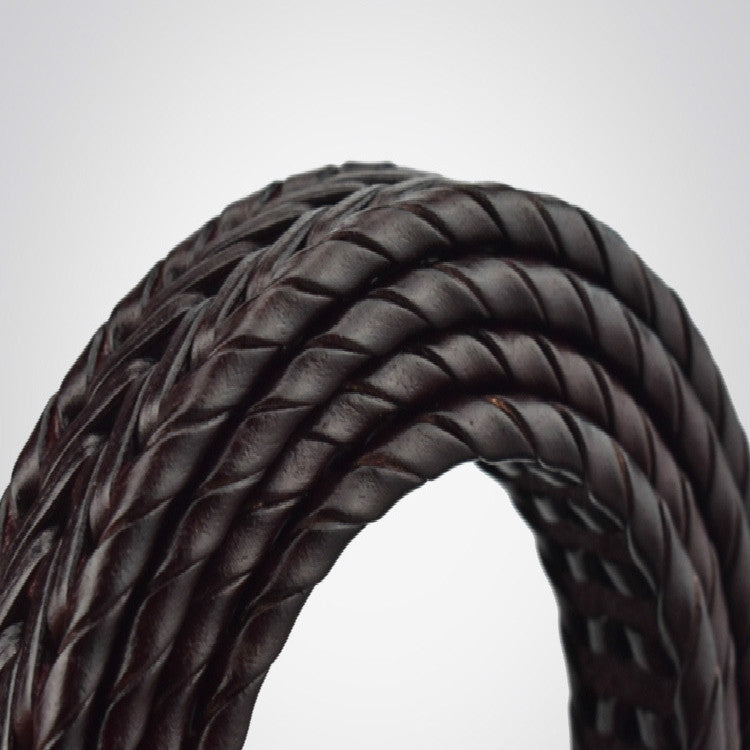 Curved close-up of black braided leather belt showing woven texture