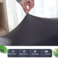 Dark gray sofa cover fabric close-up, hands adjusting the fitted stretch cover