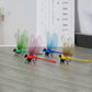 Four colorful dragonfly stick-on decorations with translucent wings on tabletop