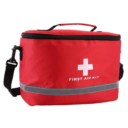 Red first aid kit bag with handle, cross logo, and reflective gray band