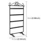 Black jewelry display stand with four rows of studded bars and top earring hooks.