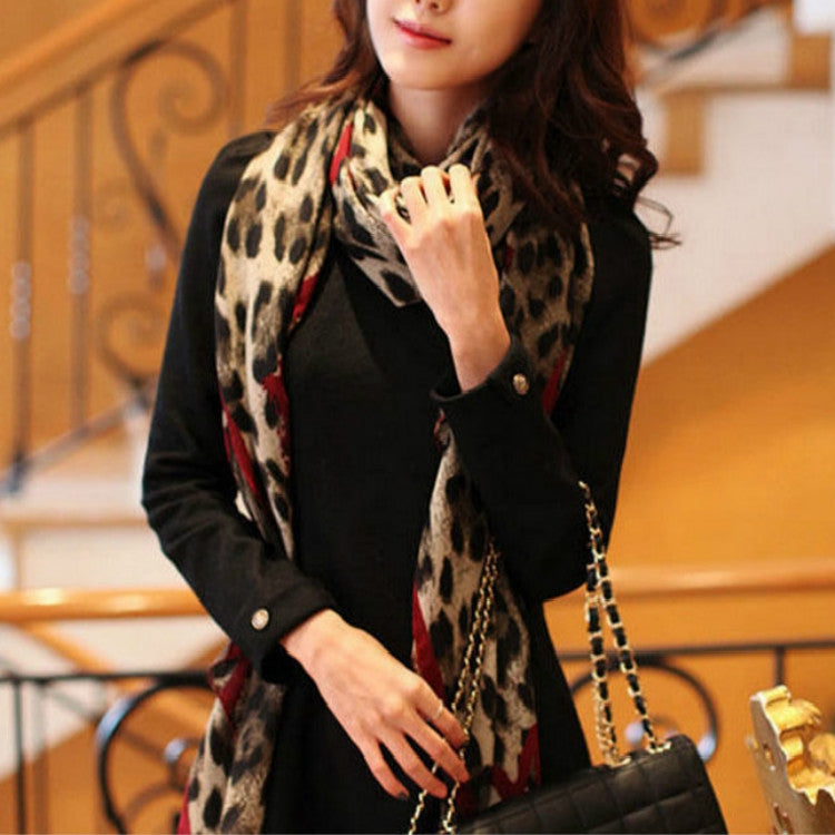 Leopard-print scarf shawl with red and dark accents, worn around neck