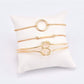 Gold-tone chain bracelet set with ring and double-knot loop detail, flat lay
